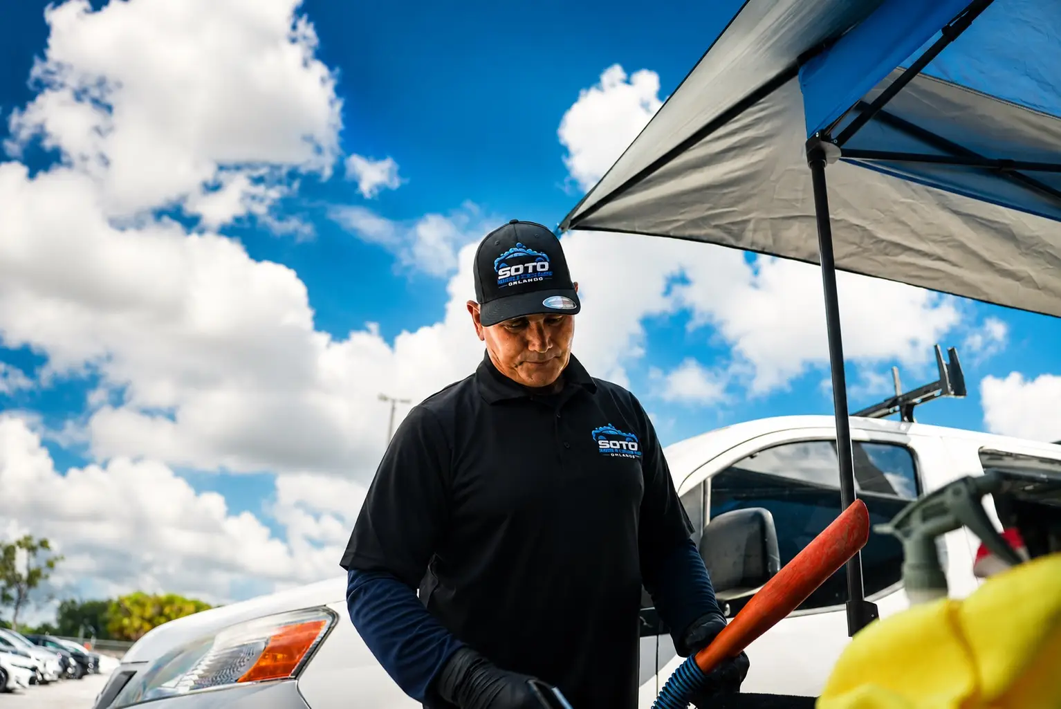 Mobile detailing company in Orlando, FL · services section Mobile detailing company in Orlando, FL · detailer working under the mobile canopy